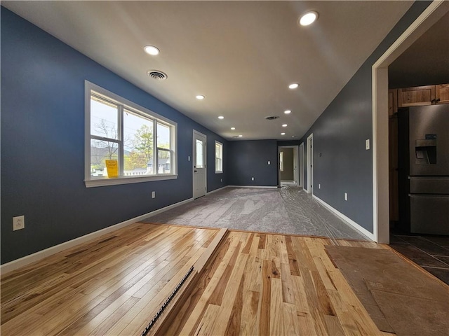 unfurnished living room featuring recessed lighting, visible vents, and light wood-style floors