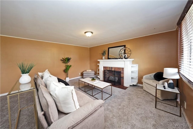 carpeted living area with a brick fireplace, baseboards, and ornamental molding