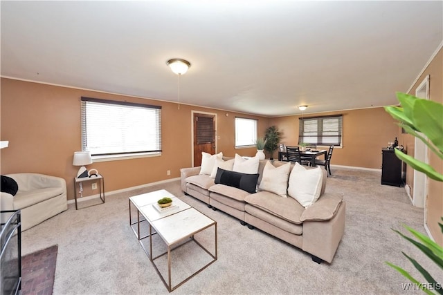 living area featuring carpet floors and baseboards