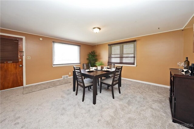 dining space featuring visible vents, baseboards, and crown molding