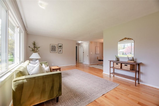 living area featuring light wood-style floors and baseboards