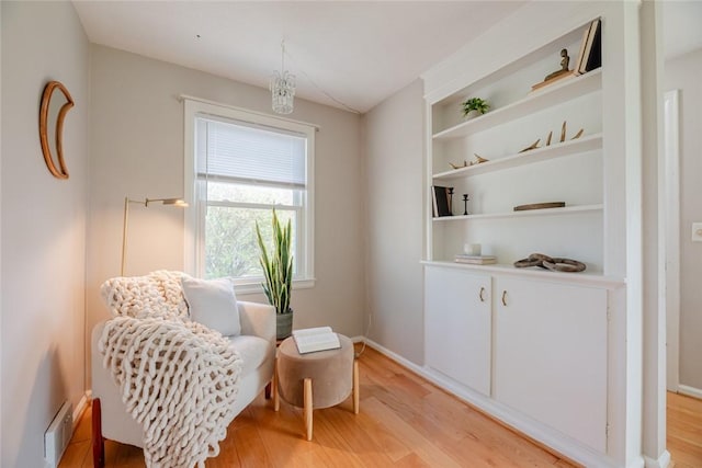 living area with baseboards and light wood-type flooring