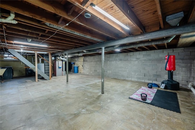 unfinished basement with heating unit and water heater