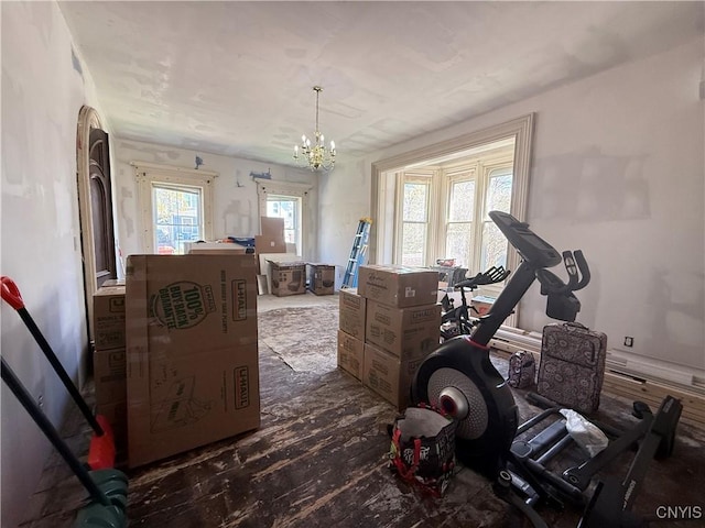 workout area with an inviting chandelier