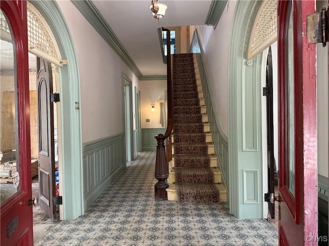 118 E 3rd St, Oswego, NY 13126 - entrance foyer with ornamental molding, wainscoting, stairway, and a decorative wall