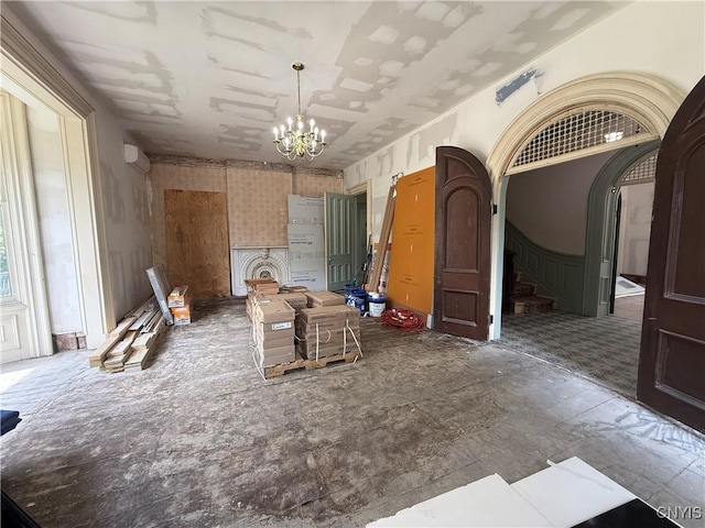 118 E 3rd St, Oswego, NY 13126 - spare room featuring a chandelier and stairway