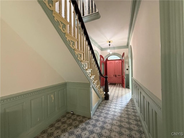 118 E 3rd St, Oswego, NY 13126 - corridor with ornamental molding, wainscoting, stairs, and a decorative wall