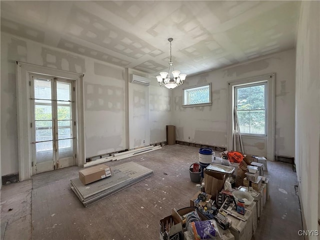 118 E 3rd St, Oswego, NY 13126 - unfurnished dining area featuring an AC wall unit and a chandelier