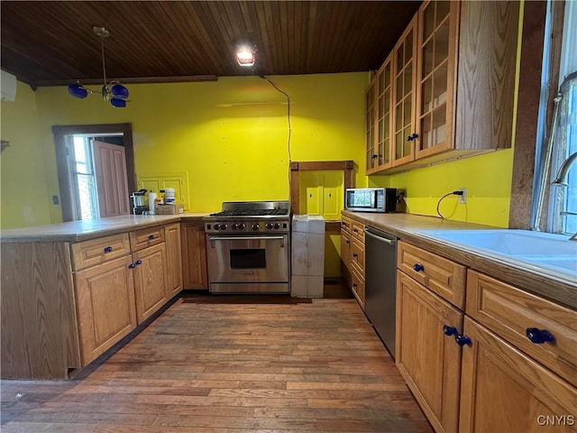 118 E 3rd St, Oswego, NY 13126 - kitchen featuring appliances with stainless steel finishes, wood ceiling, hardwood / wood-style floors, a peninsula, and glass insert cabinets