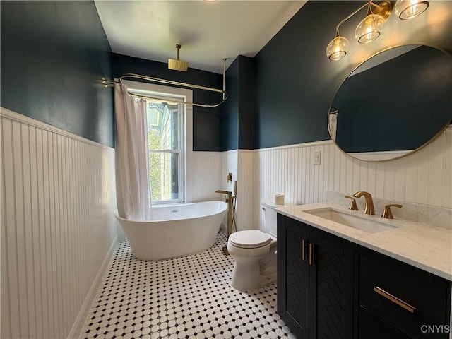 118 E 3rd St, Oswego, NY 13126 - full bath featuring a wainscoted wall, a freestanding tub, and vanity