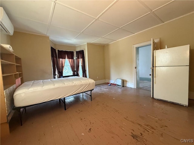 118 E 3rd St, Oswego, NY 13126 - bedroom featuring freestanding refrigerator, an AC wall unit, and wood-type flooring