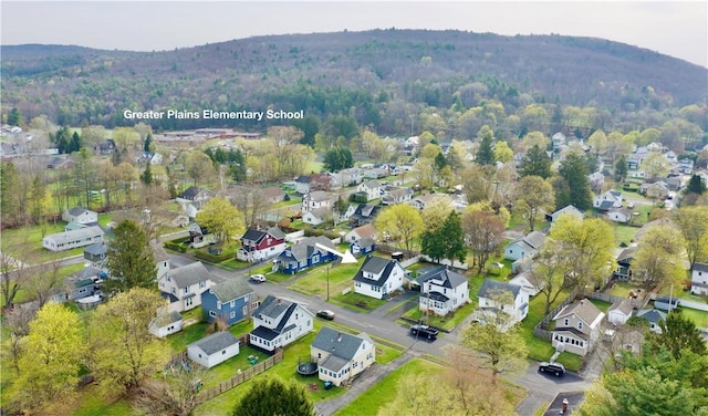 aerial view featuring a view of trees, a mountain view, and a residential view