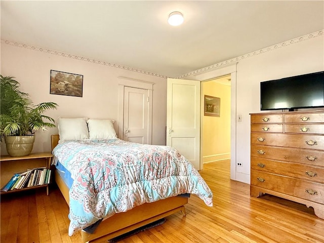 bedroom featuring light wood-type flooring and baseboards