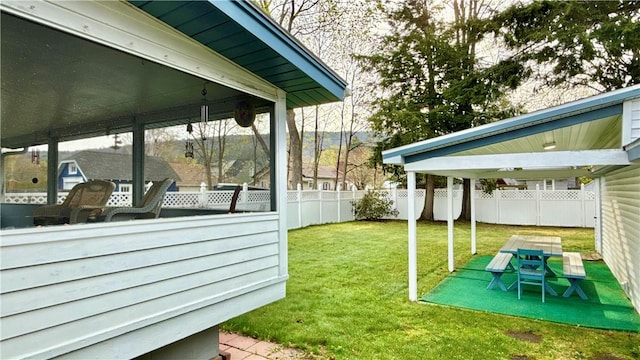view of yard featuring fence and a sunroom