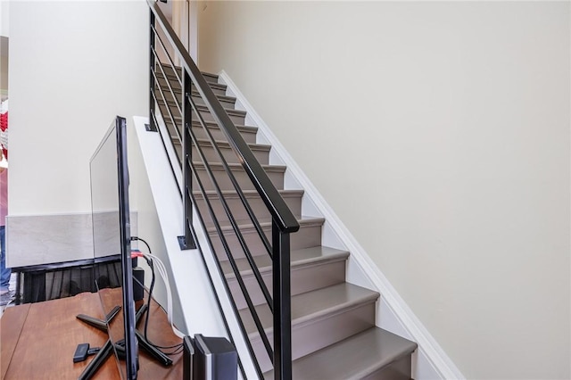 staircase featuring a towering ceiling