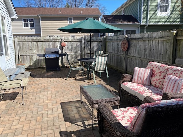 view of patio / terrace featuring an outdoor living space, a fenced backyard, and a grill
