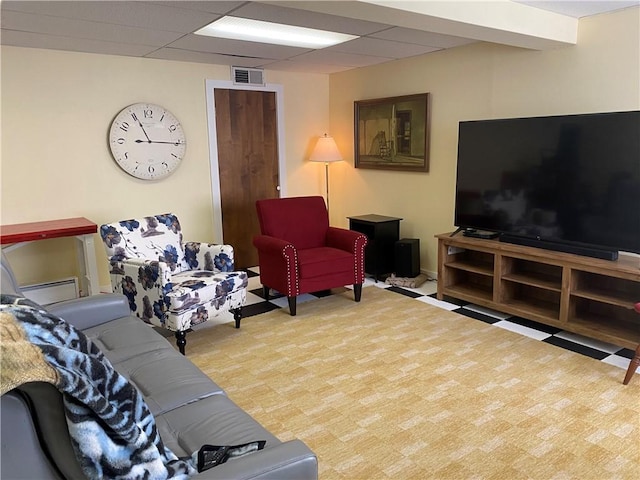 living room featuring visible vents and a paneled ceiling