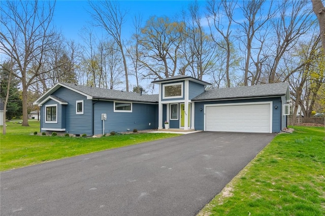 view of front of property featuring aphalt driveway, a shingled roof, a front lawn, and a garage