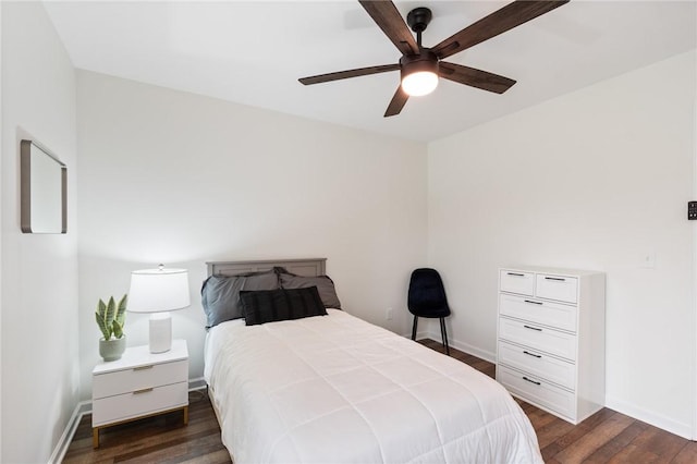 bedroom with baseboards, ceiling fan, and dark wood-type flooring