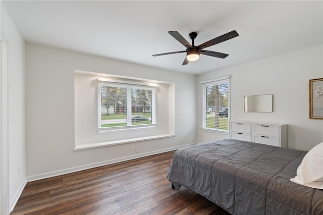 bedroom featuring a ceiling fan, baseboards, and wood finished floors