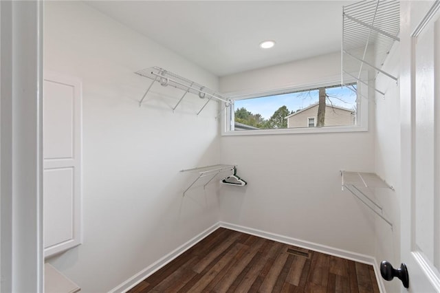 walk in closet with dark wood-type flooring and visible vents