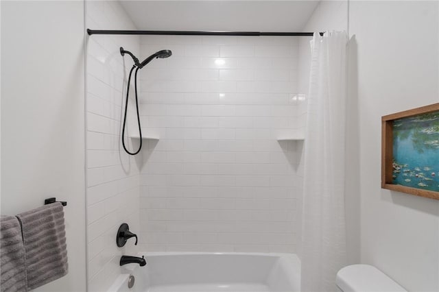 bathroom with toilet and shower / tub combo