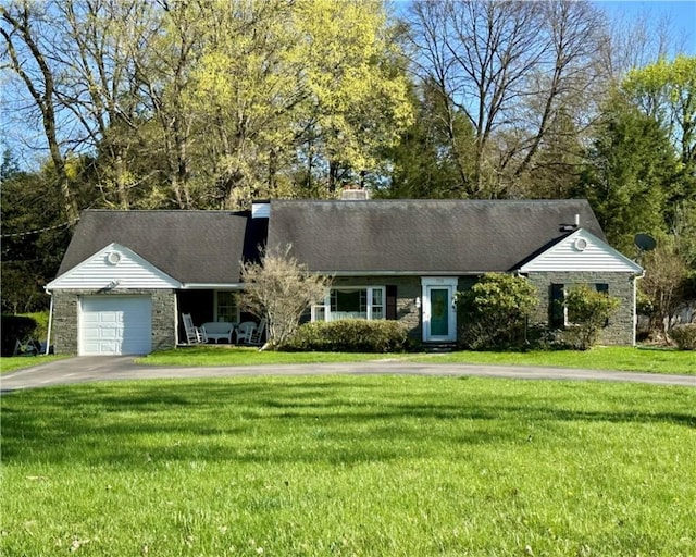 ranch-style house featuring an attached garage, driveway, and a front lawn