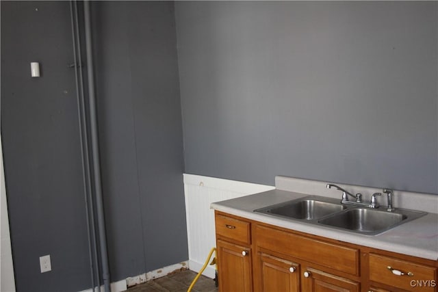 interior space with a sink, brown cabinets, and light countertops