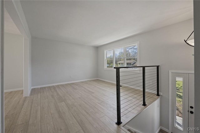 entrance foyer with baseboards, wood finished floors, and a wealth of natural light