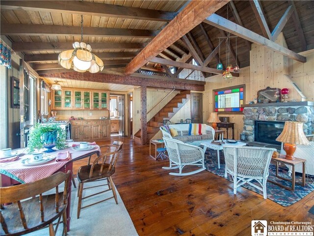 dining room with stairway, wood ceiling, vaulted ceiling with beams, and hardwood / wood-style flooring