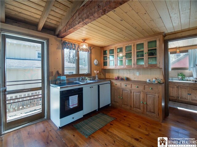 kitchen featuring dark wood-type flooring, white dishwasher, black oven, and wooden ceiling