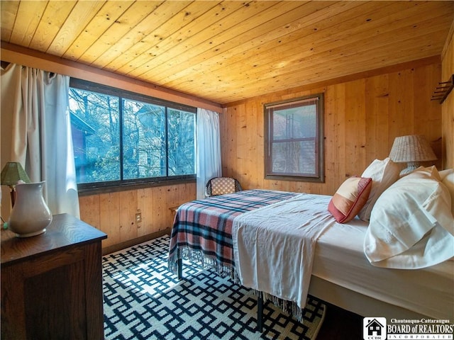 bedroom with wood walls and wooden ceiling