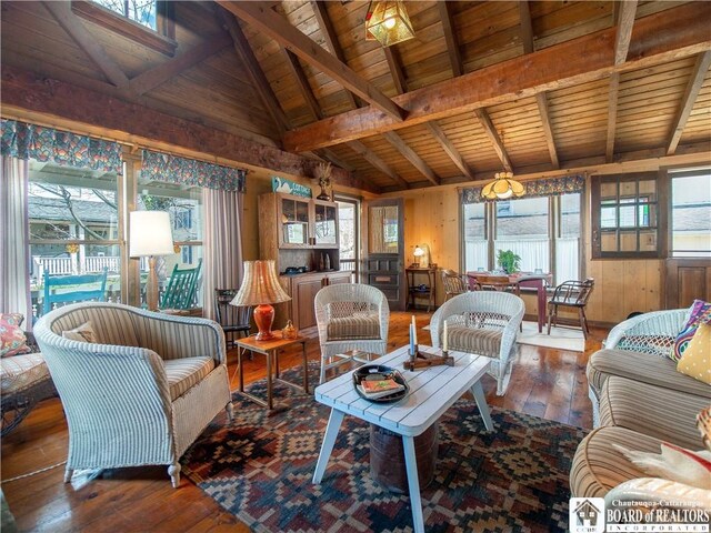 living room featuring wood ceiling, plenty of natural light, lofted ceiling with beams, and hardwood / wood-style floors