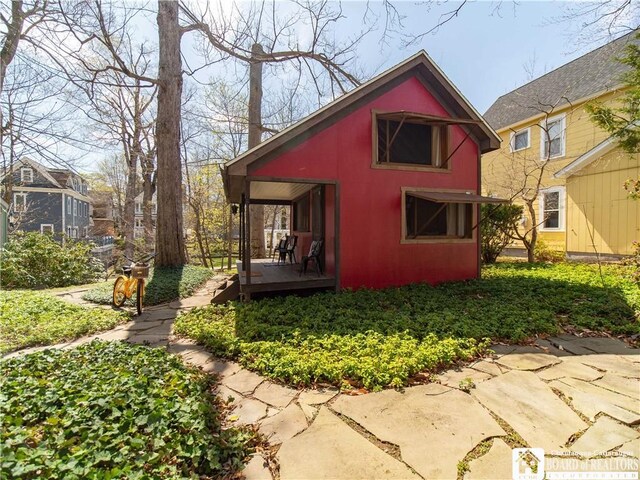 back of property featuring a deck
