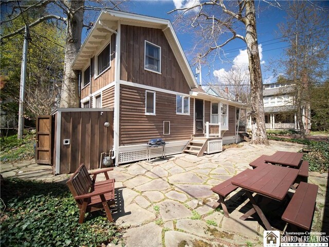 back of property with a patio