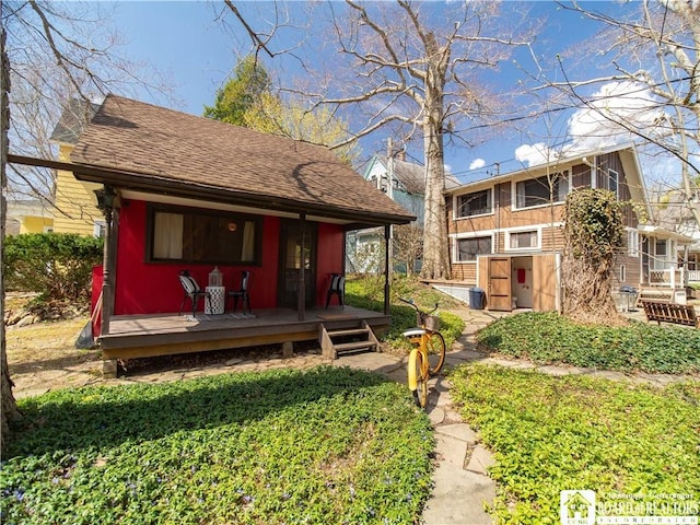 exterior space with roof with shingles