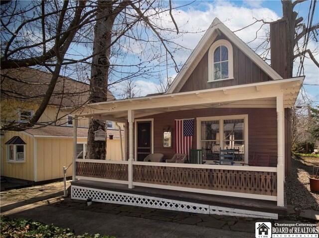 back of property with a porch and board and batten siding