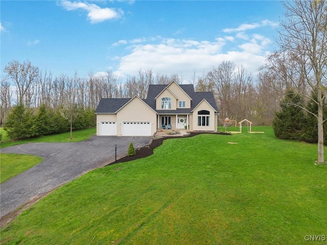 traditional home featuring a garage, a front lawn, and driveway