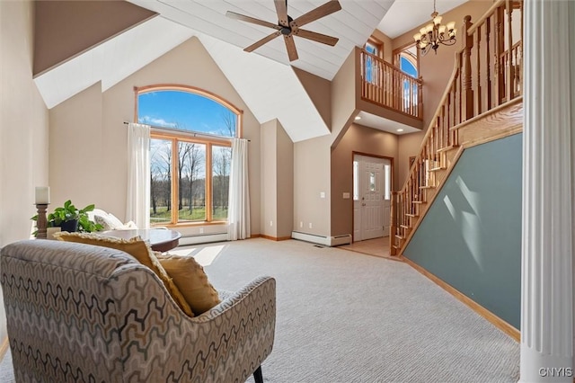 living area featuring light colored carpet, high vaulted ceiling, ceiling fan with notable chandelier, a baseboard heating unit, and stairs