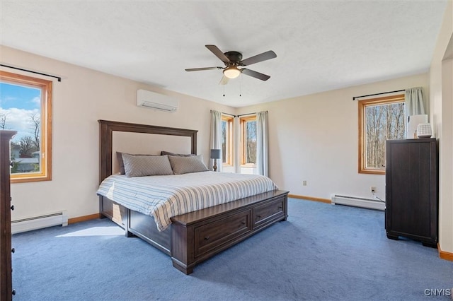 carpeted bedroom featuring baseboards, ceiling fan, a wall mounted AC, and a baseboard heating unit