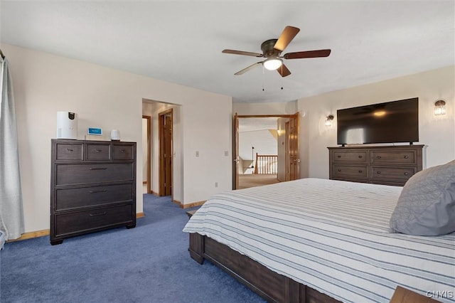 carpeted bedroom with a ceiling fan and baseboards