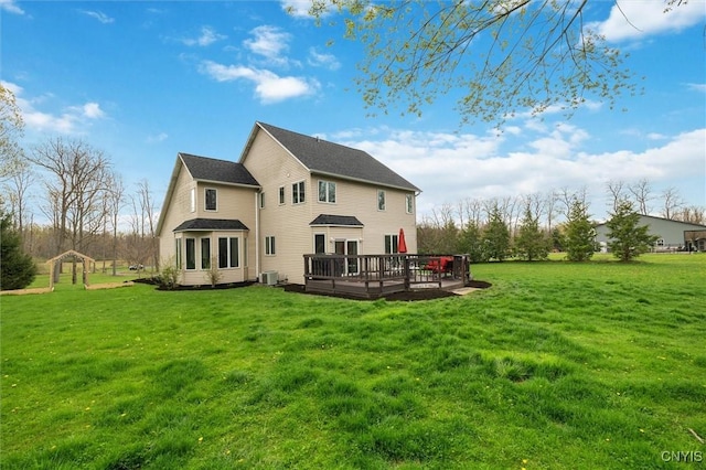 back of property featuring a yard, a wooden deck, and central AC unit