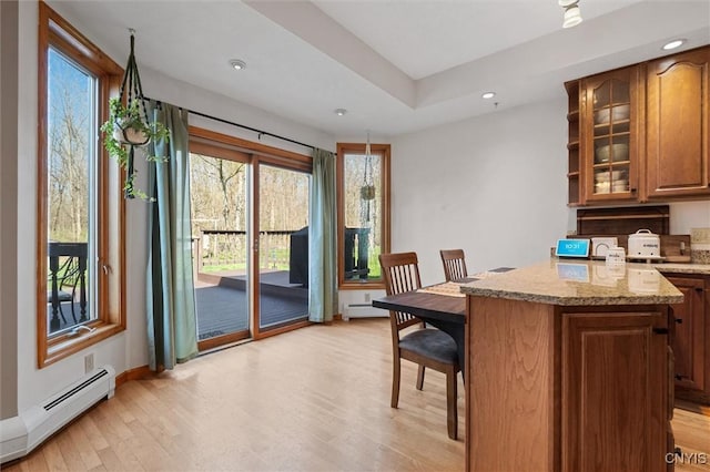 interior space featuring baseboards, a baseboard heating unit, recessed lighting, and light wood-style flooring