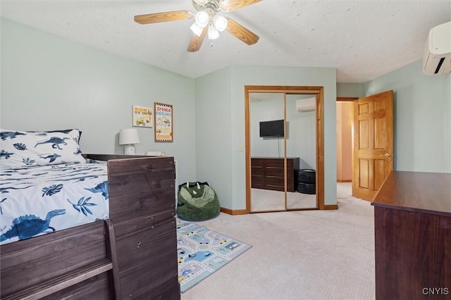 bedroom with an AC wall unit, baseboards, a closet, and light colored carpet