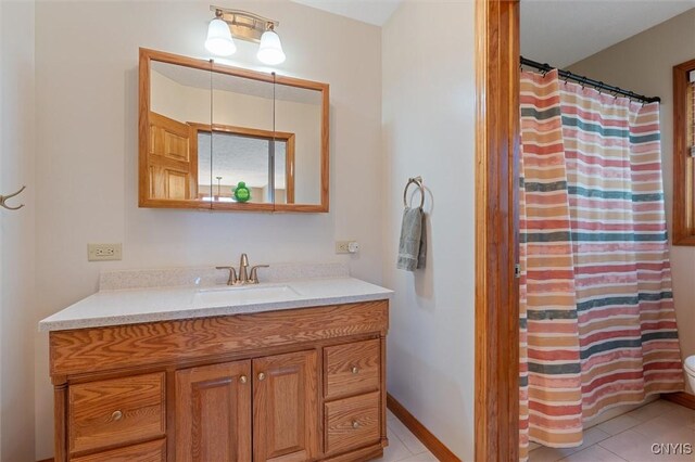 bathroom featuring tile patterned flooring, curtained shower, and vanity