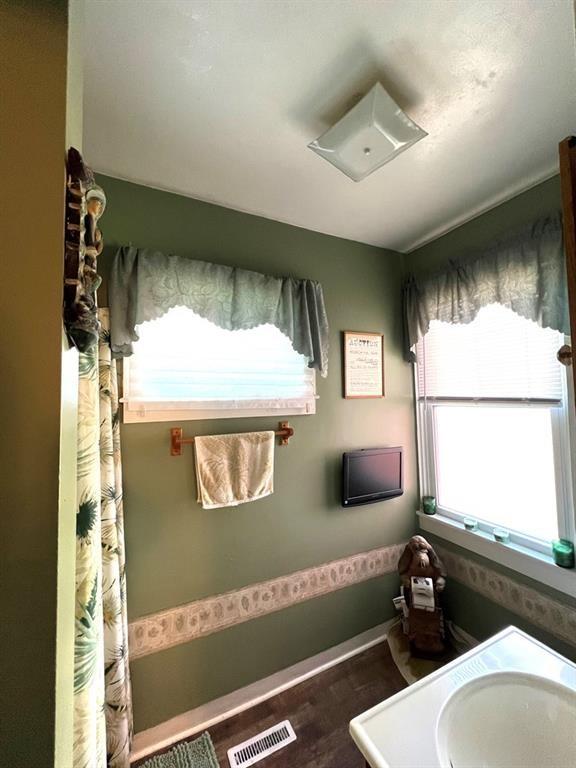 bathroom featuring visible vents and wood finished floors