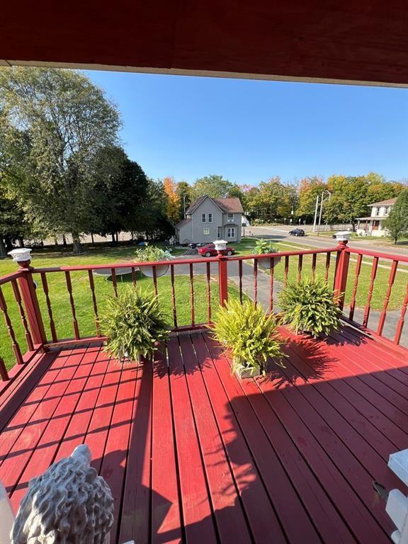wooden terrace with a lawn