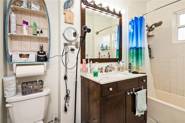 bathroom with shower / bath combo with shower curtain, toilet, and vanity