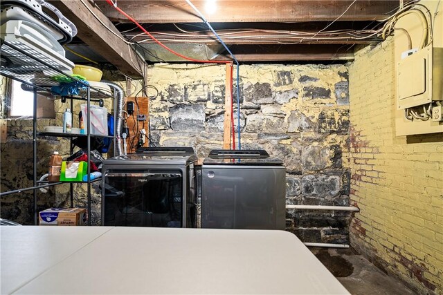 clothes washing area featuring laundry area and washer and clothes dryer