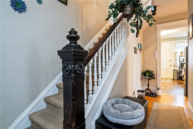 staircase with wood finished floors
